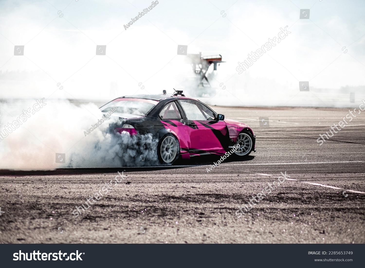 pink car drifting, Blurred image diffusion race drift car with lots of smoke from burning tires on speed track #2285653749