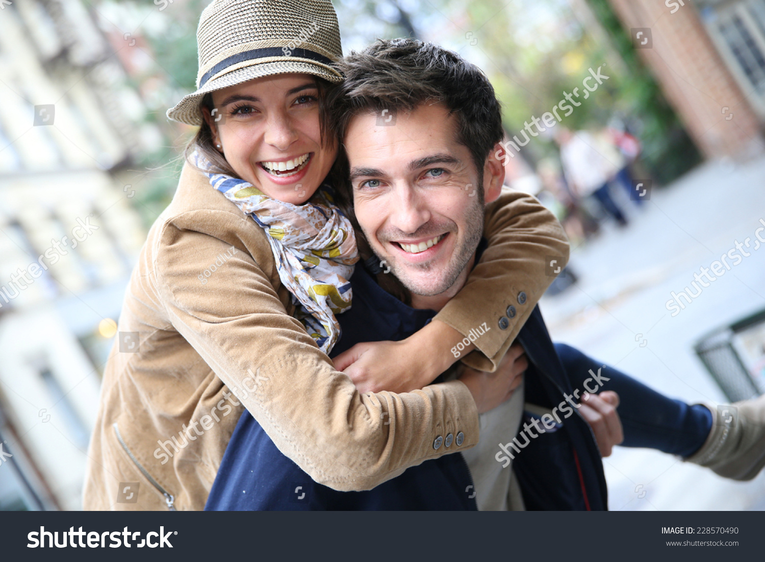 Man giving piggyback ride to girlfriend, having fun #228570490