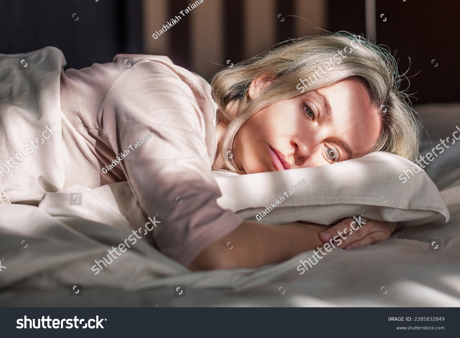 Stressed middle aged woman lying on bed at home and crying. Unhappy woman suffering from nervous tension, emotional disorders, psychological problems, breakup. Frustrated female feeling lonely  #2285832849