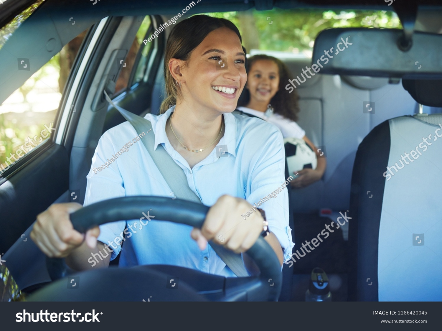 Travel, mother and child in car for drive, fun and sports, soccer and adventure, happy and excited. Mom, driver and girl passenger in vehicle, smile and bonding on road trip to football activity #2286420045