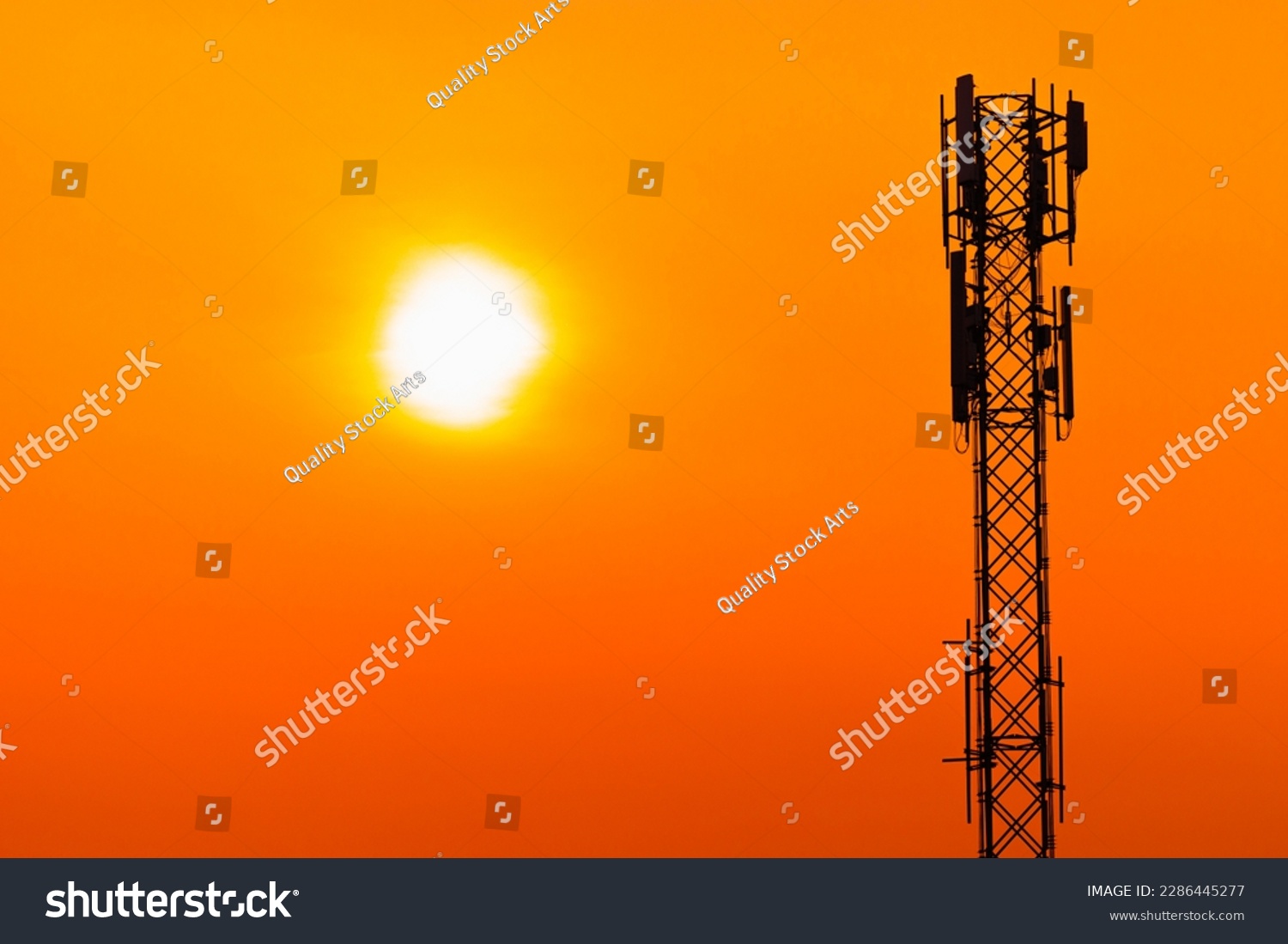 5G Cell Site Digital Cellular Telecommunication Tower Network Antenna on clear sunset orange sky background. #2286445277
