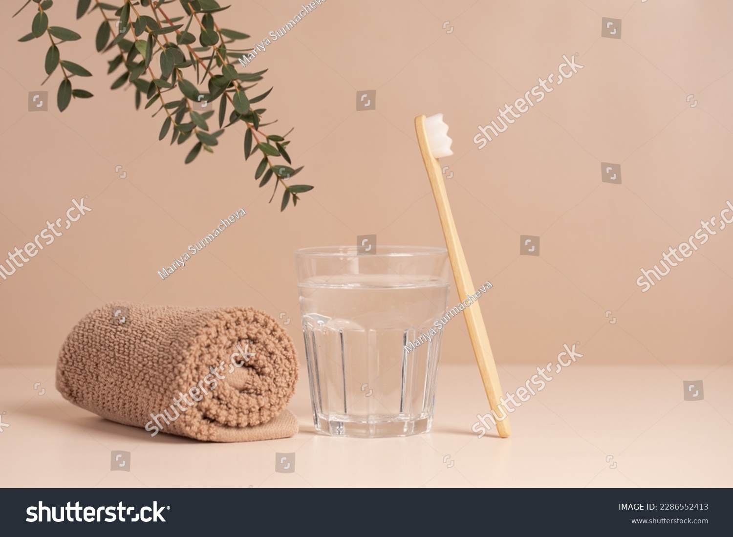 Bamboo toothbrush, towel and a glass of water. Eco-friendly items. Oral care. Biodegradable personal care products. #2286552413