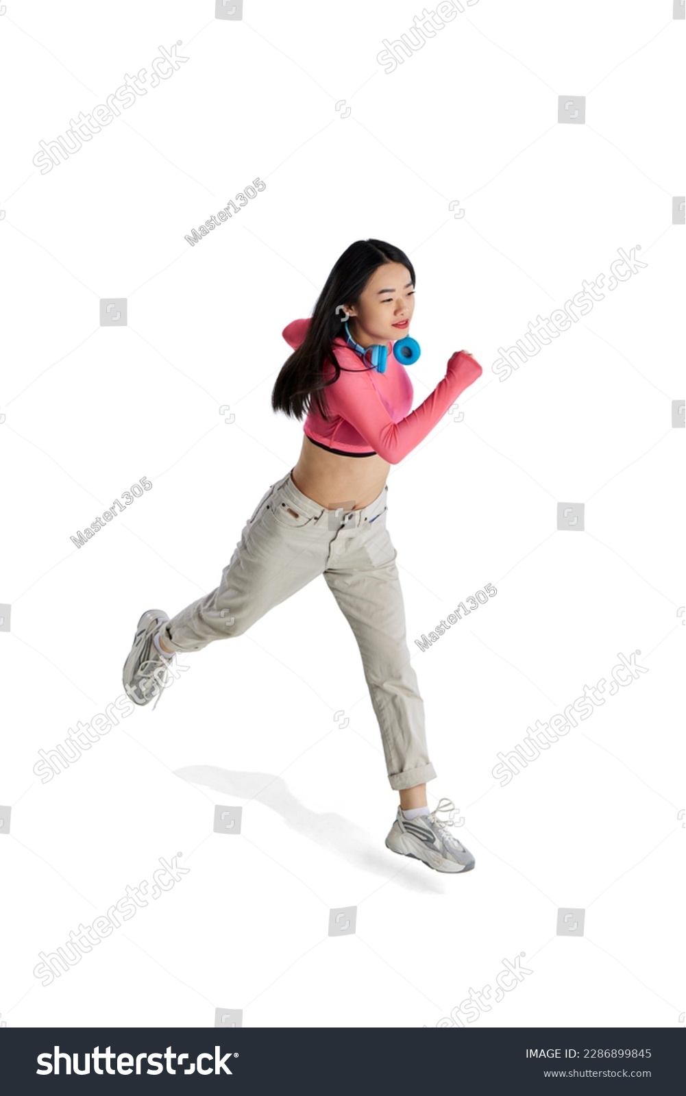 Top isometric view. Young girl with headphones in casual clothes in motion, running isolated over white background. Concept of business, employment, education. lifestyle. Copy space for ad #2286899845
