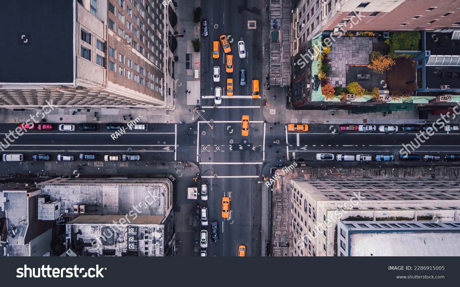 Aerial view of Midtown Manhattan at sunset with a view yellow cabs driving around the city. New York city taxi cabs at the crossroad.  #2286915005