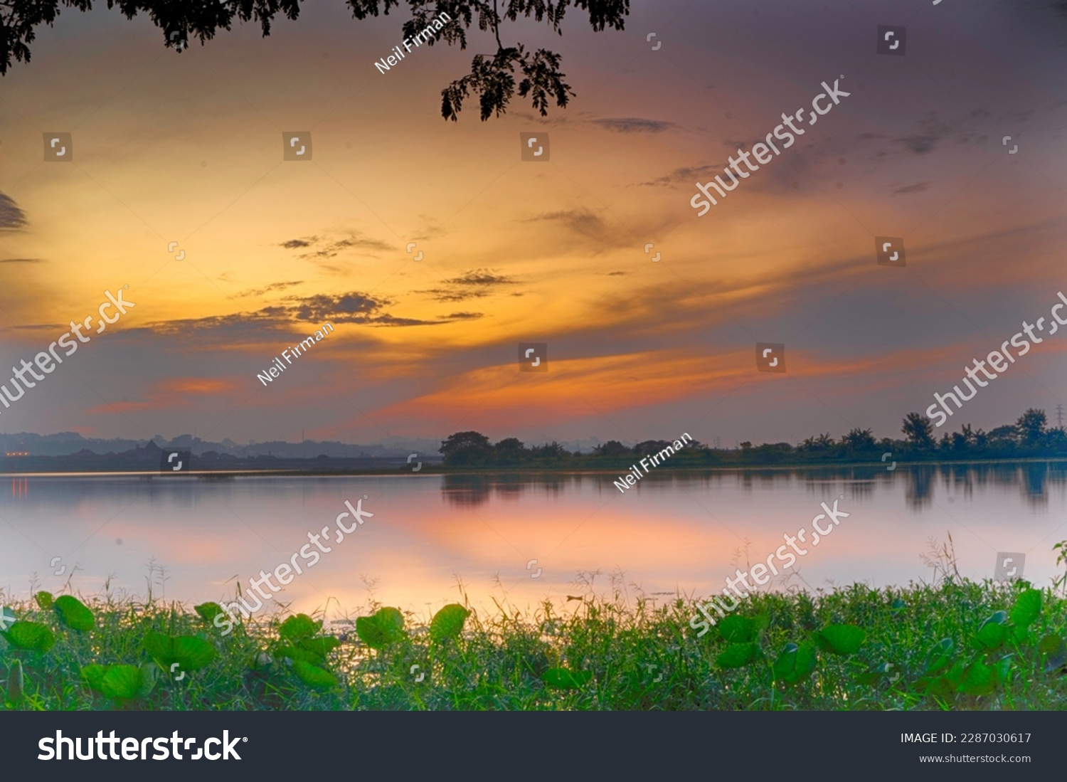 Beautiful view of Waduk Bunder or Water Dam Bunder in Gresik, East Java, Indonesia during sunrise and cloudy wheater. #2287030617