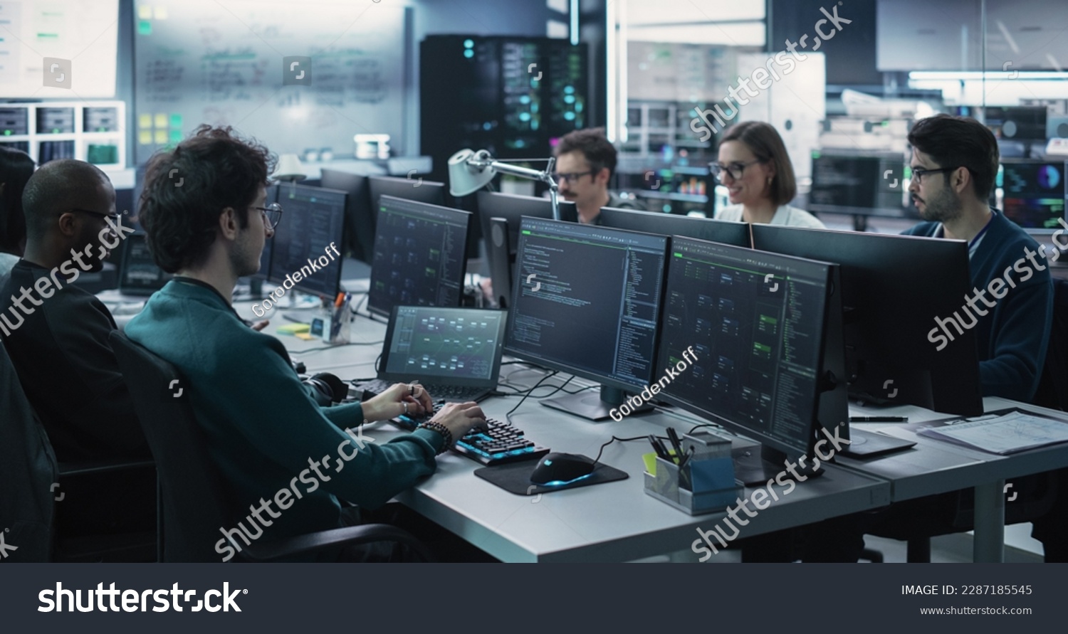 Group of Empowered Multicultural Men and Women Working in a Research Center, Using Computers to Run Advanced Software, Develop Artificial Intelligence Interface and Cyber Security Protocols #2287185545