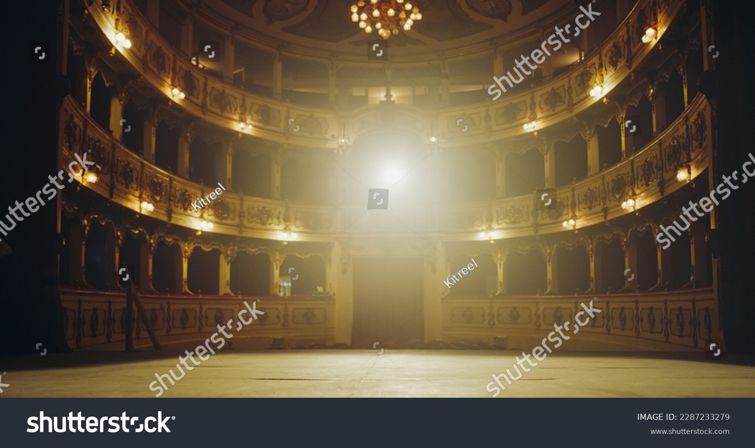 Wide shot of an Empty Elegant Classic Theatre with Spotlight Shot from the Stage. Well-lit Opera House with Beautiful Golden Decoration Ready to Recieve Audience for a Play or Ballet Show #2287233279