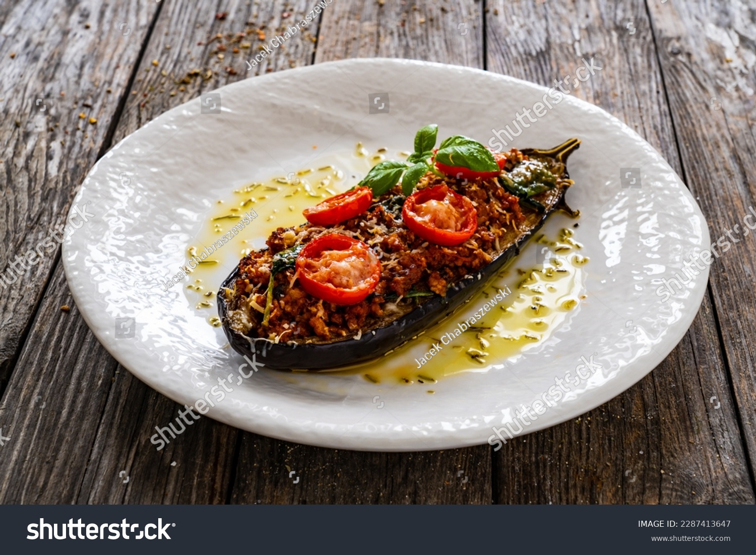 Roasted aubergine stuffed with minced meat and cheese on wooden table  #2287413647