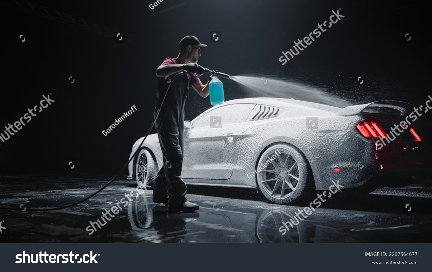Professional Car Wash Specialist Applying Smart Foam to Prepare a Modern Red Sportscar with Retro Design for Sale at a Dealership Car Center. Commercial Studio Photo for Advertising #2287564677
