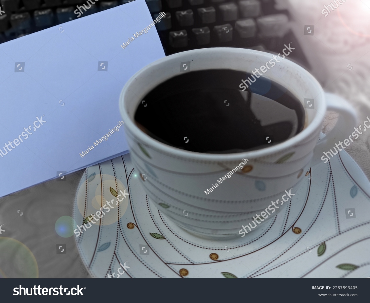 Closeup of a cup of black coffee with blank white notepaper and old typewriter keyboard. Copy space for business and personal reminder notes concept. #2287893405