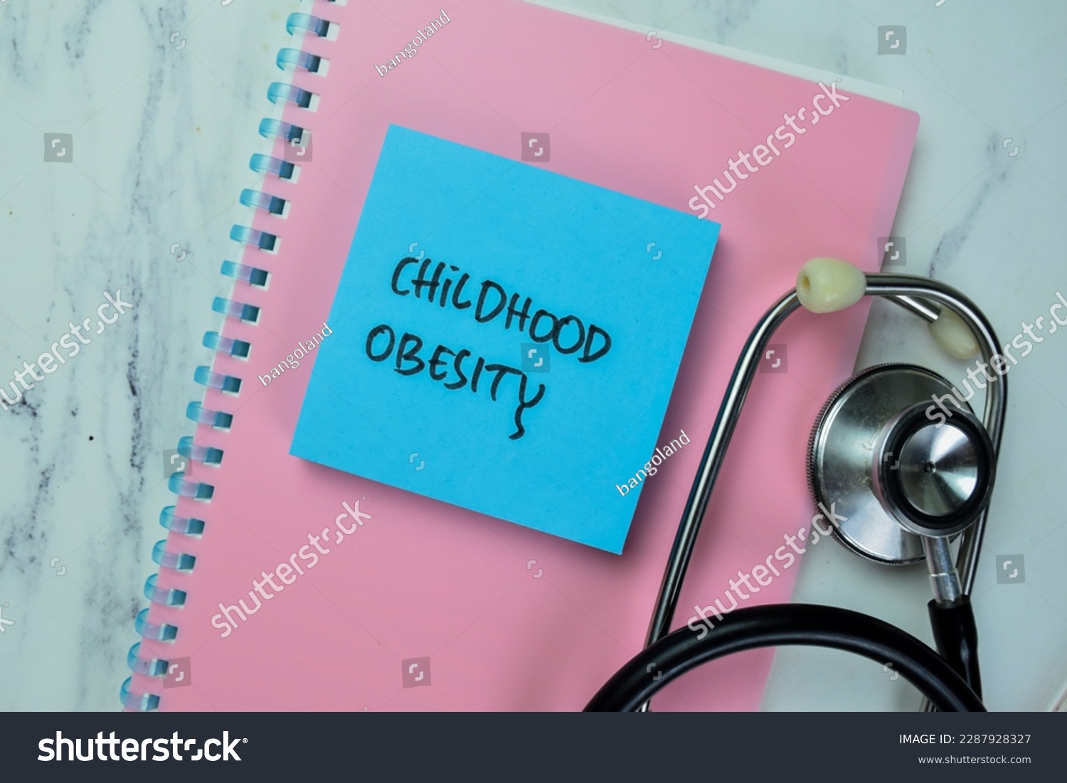 Concept of Childhood Obesity write on sticky notes isolated on Wooden Table. #2287928327