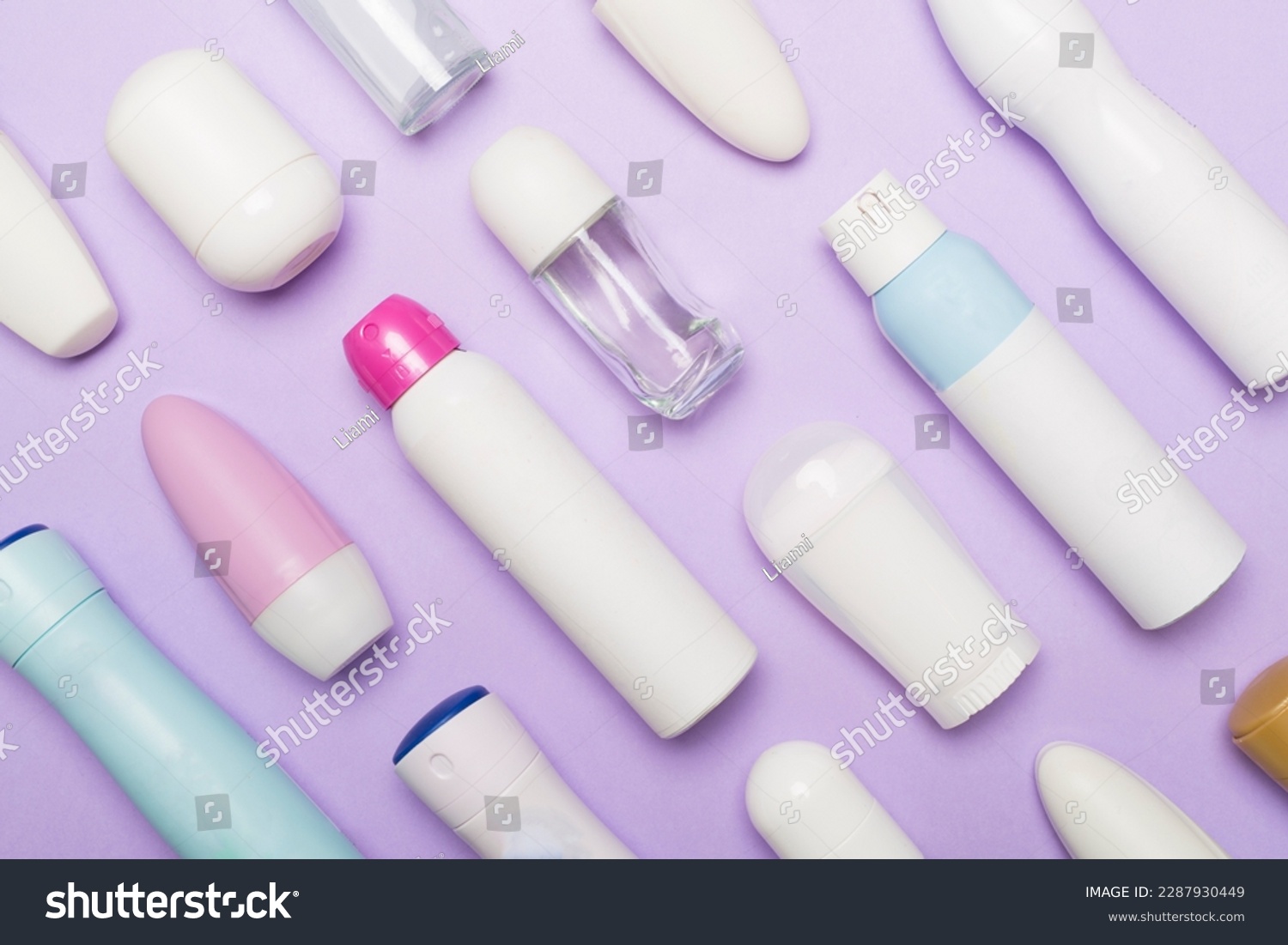 Many different deodorants on color background, top view #2287930449