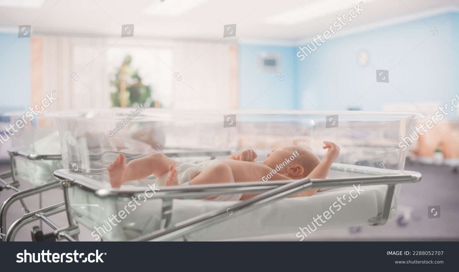 Adorable Caucasian Newborn Child Lying in Hospital Bed in a Nursery Clinic. Little Playful and Healthy Baby. Medical Health Care, Maternity and Parenthood Concept #2288052707