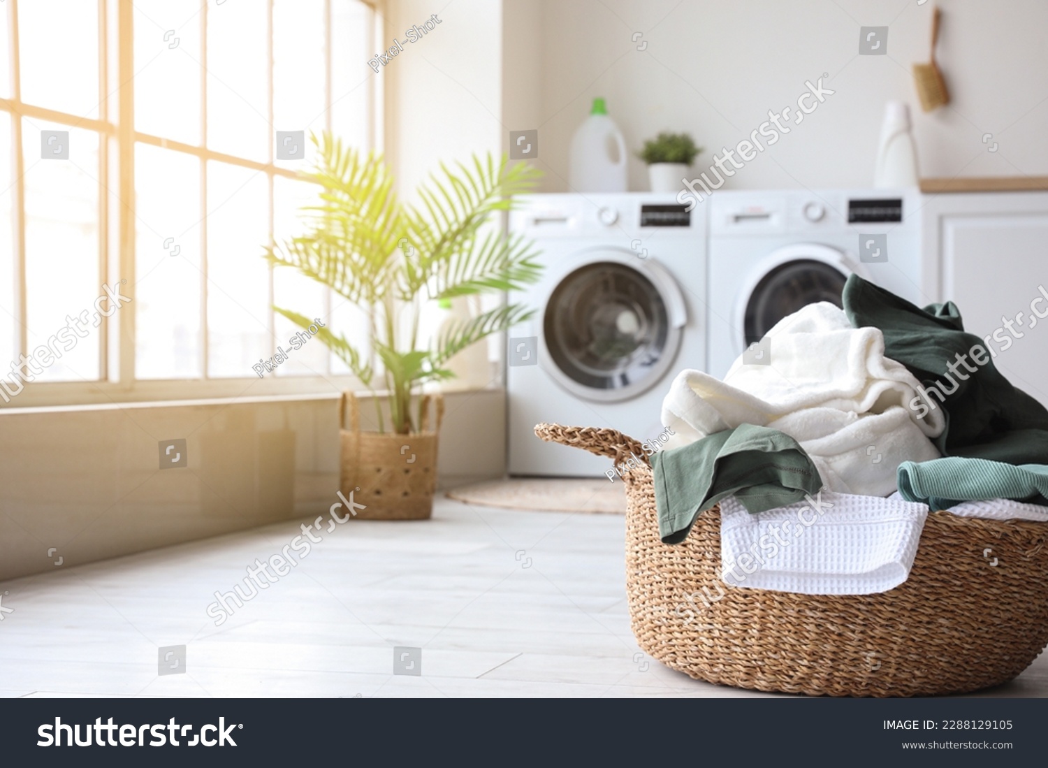 Basket with dirty clothes in laundry room #2288129105