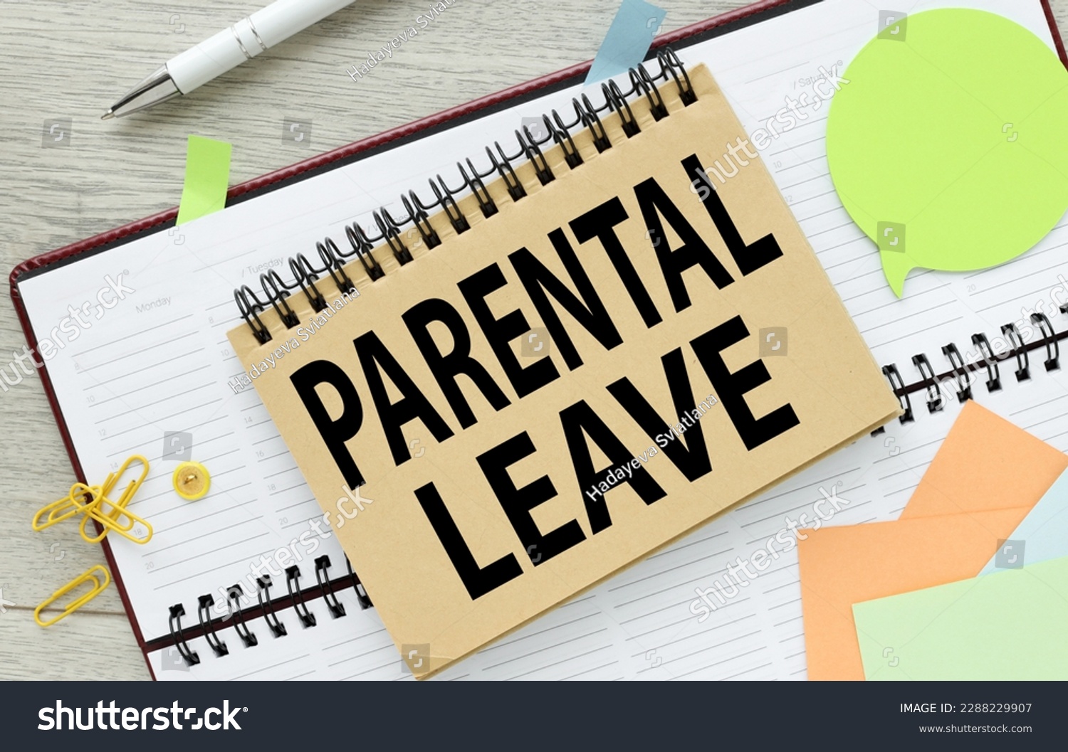 PARENTAL LEAVE text on an open notepad. on the diary. #2288229907