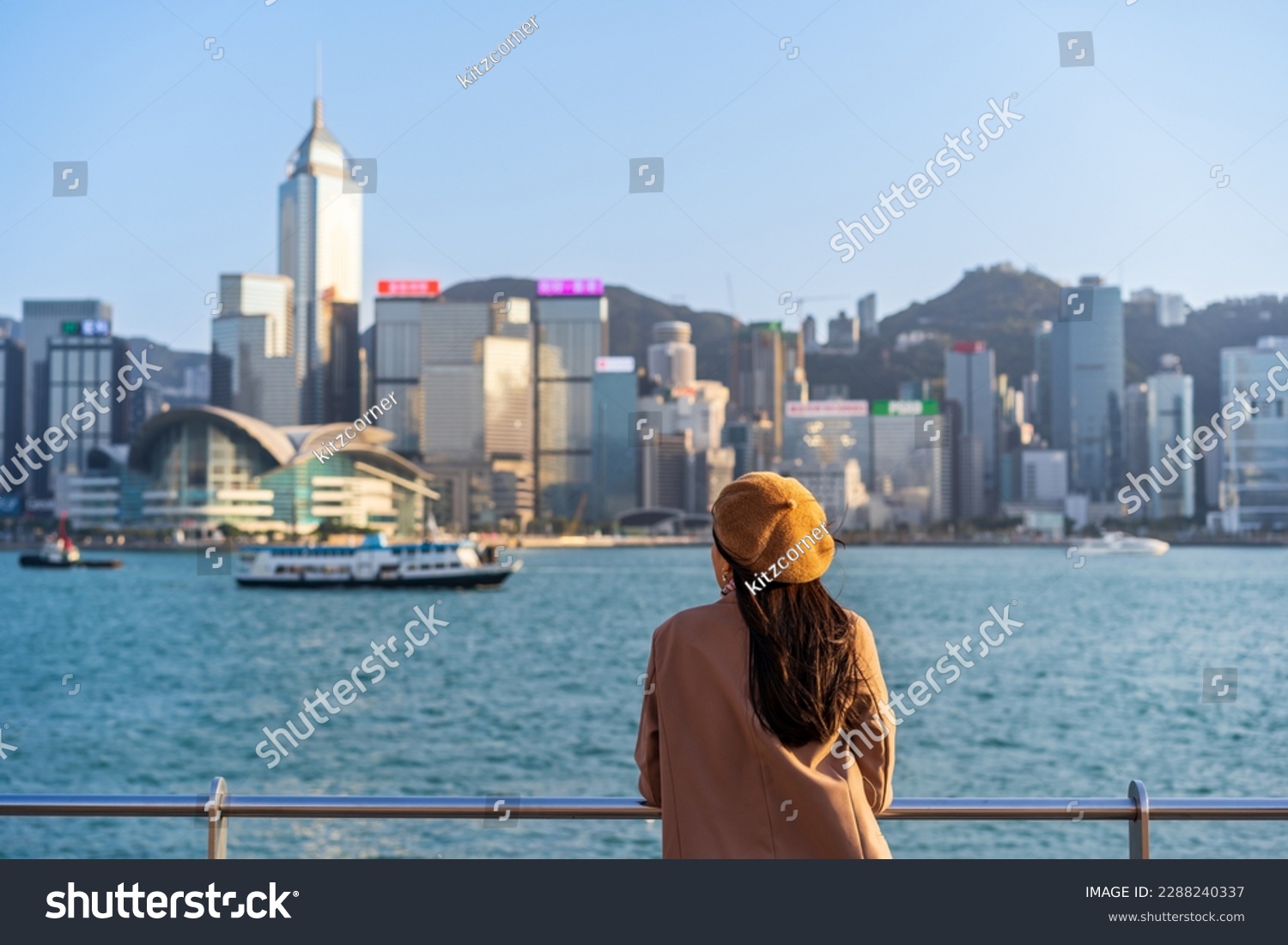 Young woman traveler relaxing and enjoying the sunset atmosphere at Victoria harbour in Hong Kong #2288240337