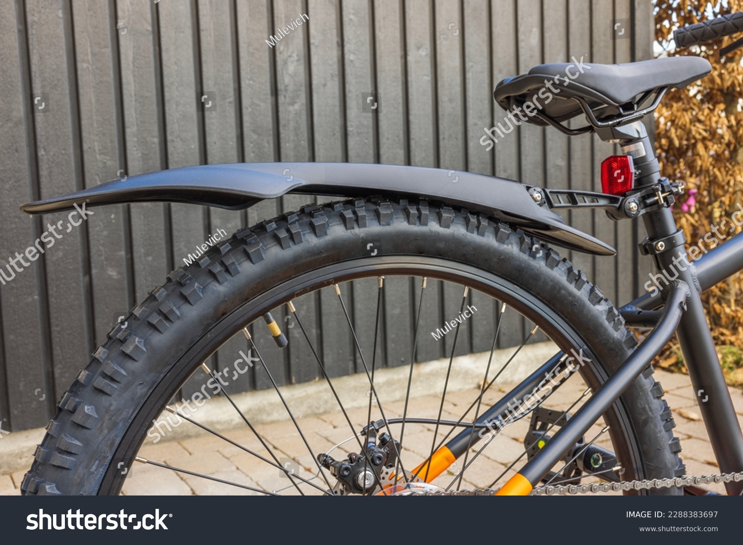 Close-up view of rear wheel of mountain bike with fender. Sweden. #2288383697