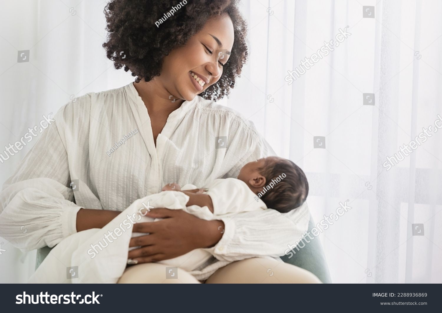 Close up portrait of beautiful young African American  mother holding sleep newborn baby in hospital bed room. Healthcare medical love black afro woman lifestyle mother's day, breast with copy space.  #2288936869