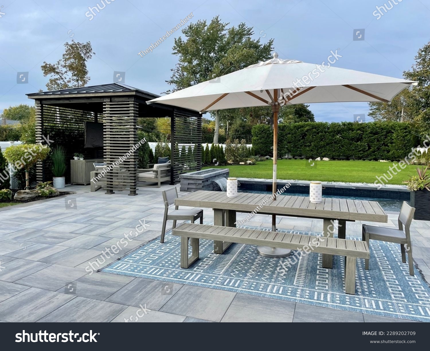 Gorgeous outdoor living backyard patio with pergola, outdoor rug,  tequila bar, dining set, couch, television, pool with waterfall , fire pit and stunning Techo Bloc patio pavers - Inspired by tulum. #2289202709
