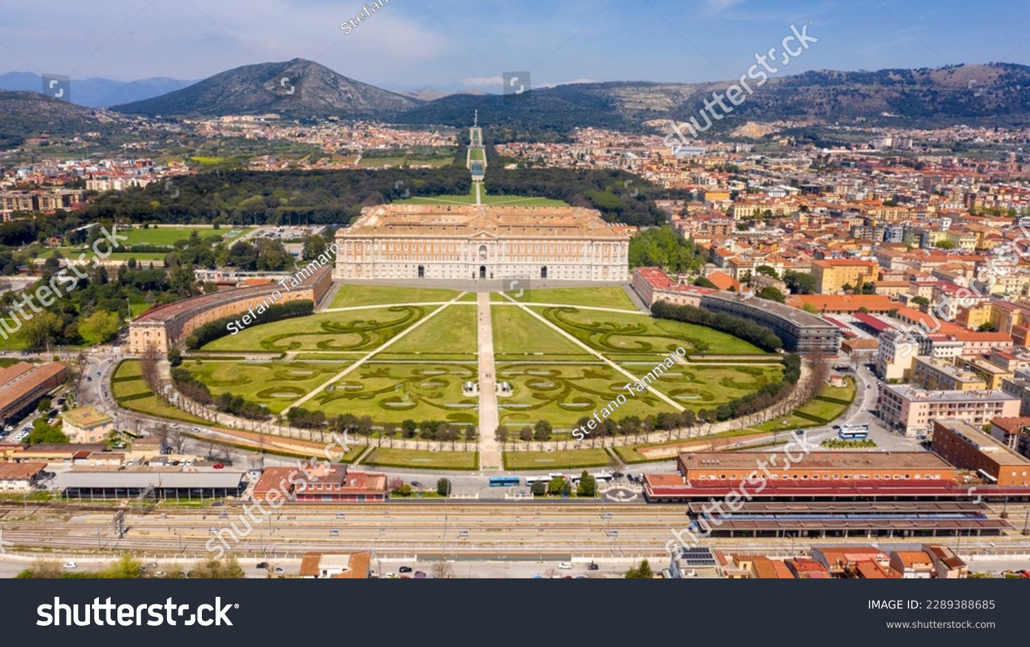 Aerial view of the Royal Palace of Caserta also known as Reggia di Caserta. It is a former royal residence with large gardens in Caserta, near Naples, Italy. It is the main facade of the building. #2289388685