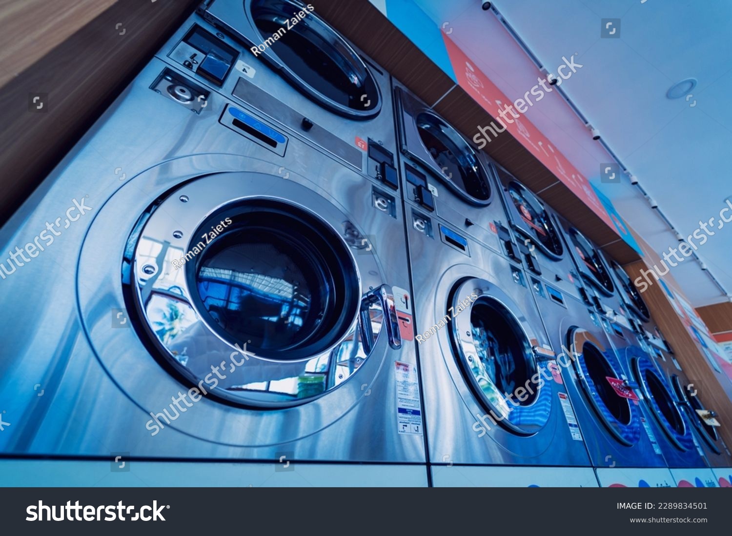 Rows of industrial laundry machines in the large laundromat. #2289834501