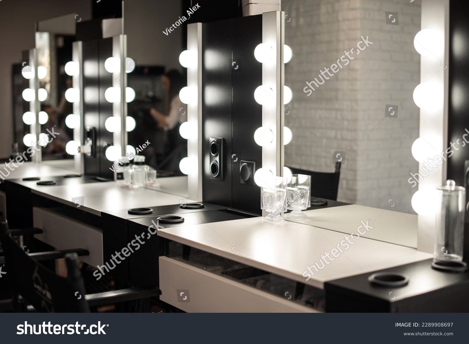 Blurred background of a beauty salon, a make-up table with lighting, cinema lights, interior of a hairdressing salon #2289908697