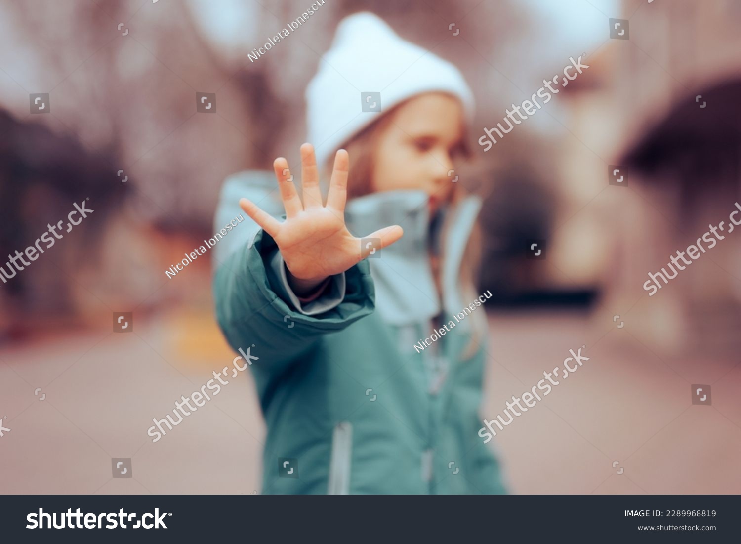 
Unhappy Preschool Little Girl Making a Stop Bullying Gesture. Desperate bullied child defending herself making halt sign
 #2289968819