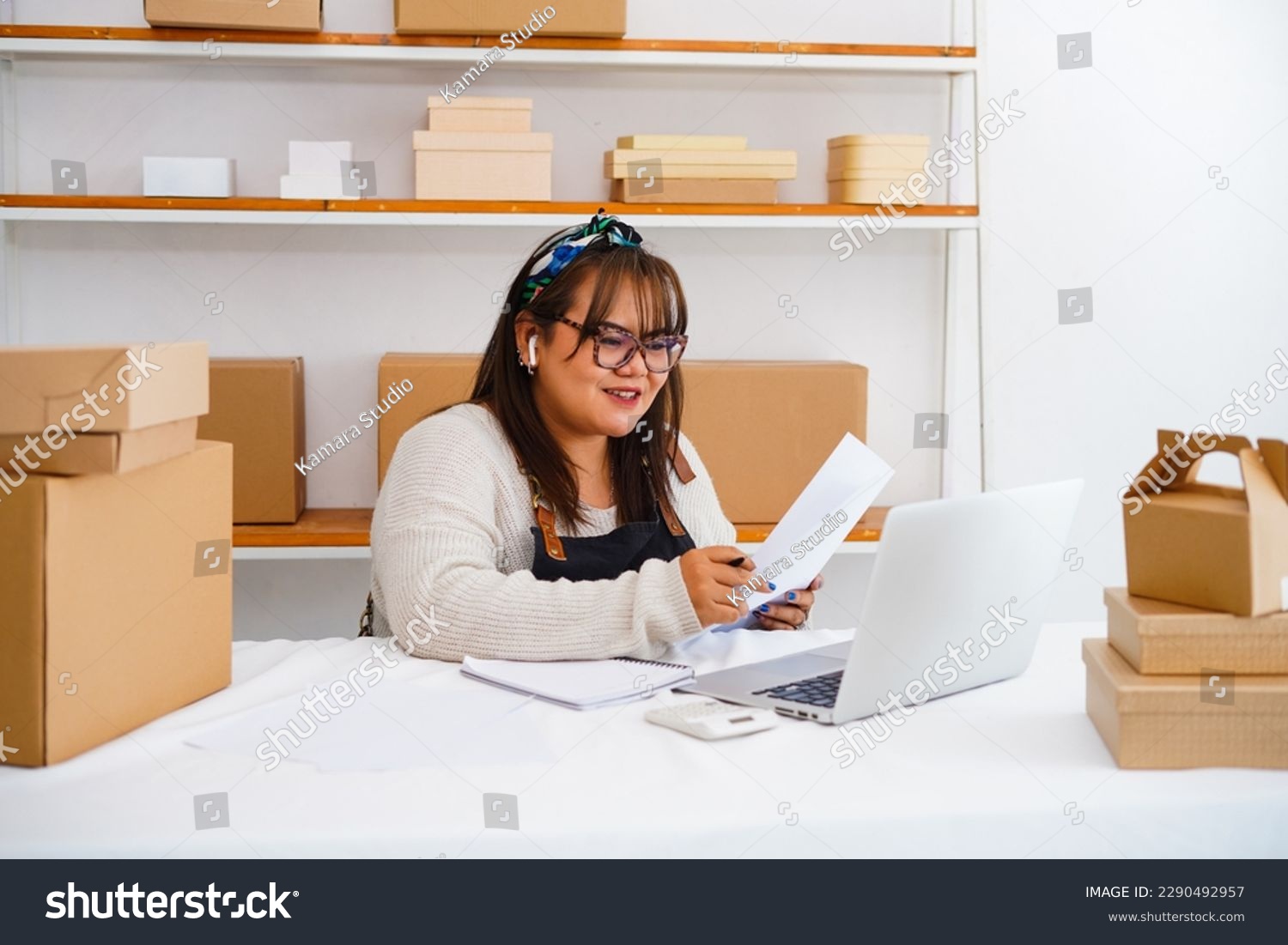 Photo of asian woman enterpreneur wear headset look at laptop talk to tutor use videoconference, heap of textbooks on table. Digital online educational course, videocall event concept #2290492957
