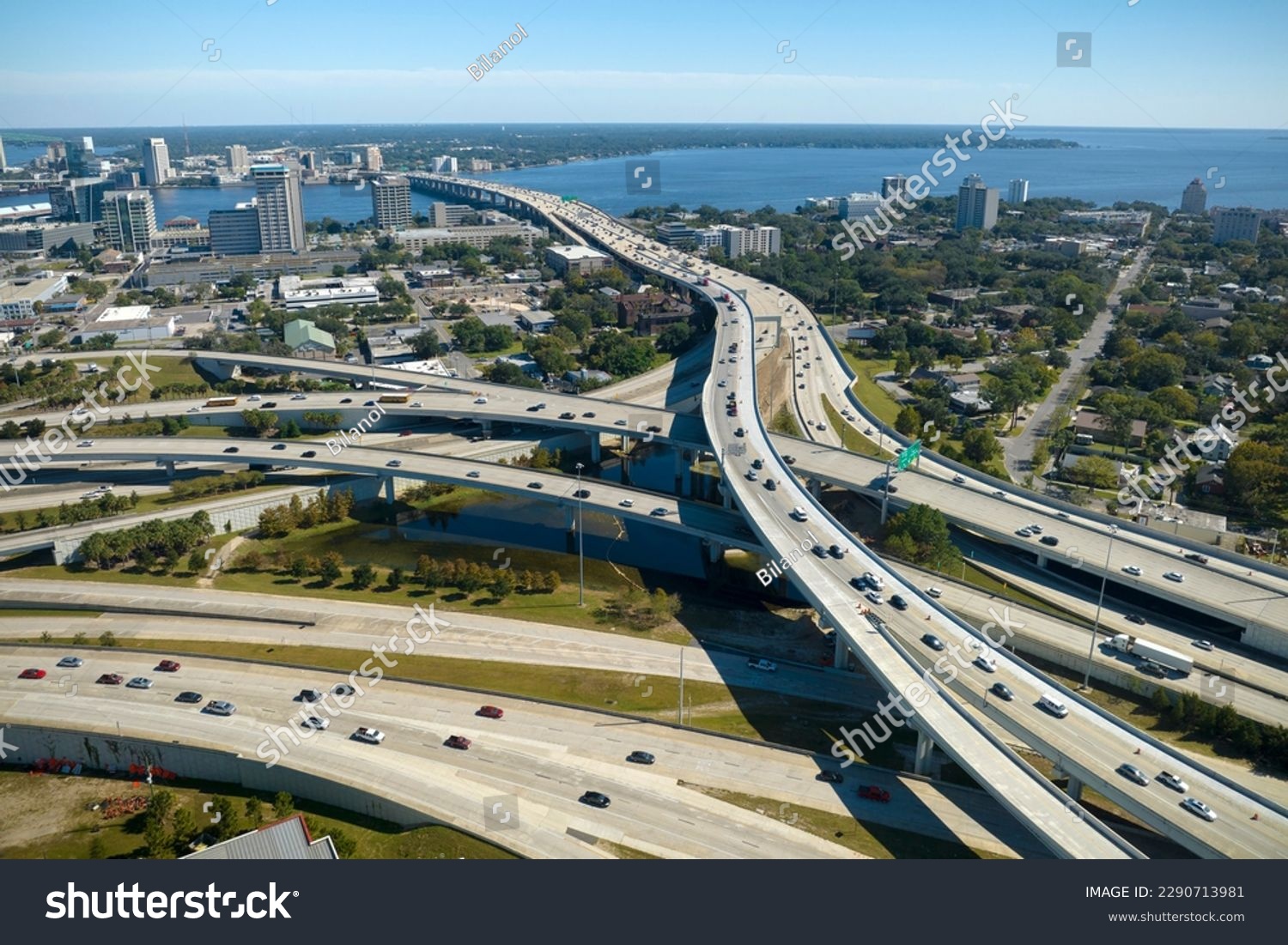 Aerial view of american freeway intersection with fast moving cars and trucks. USA transportation infrastructure concept #2290713981