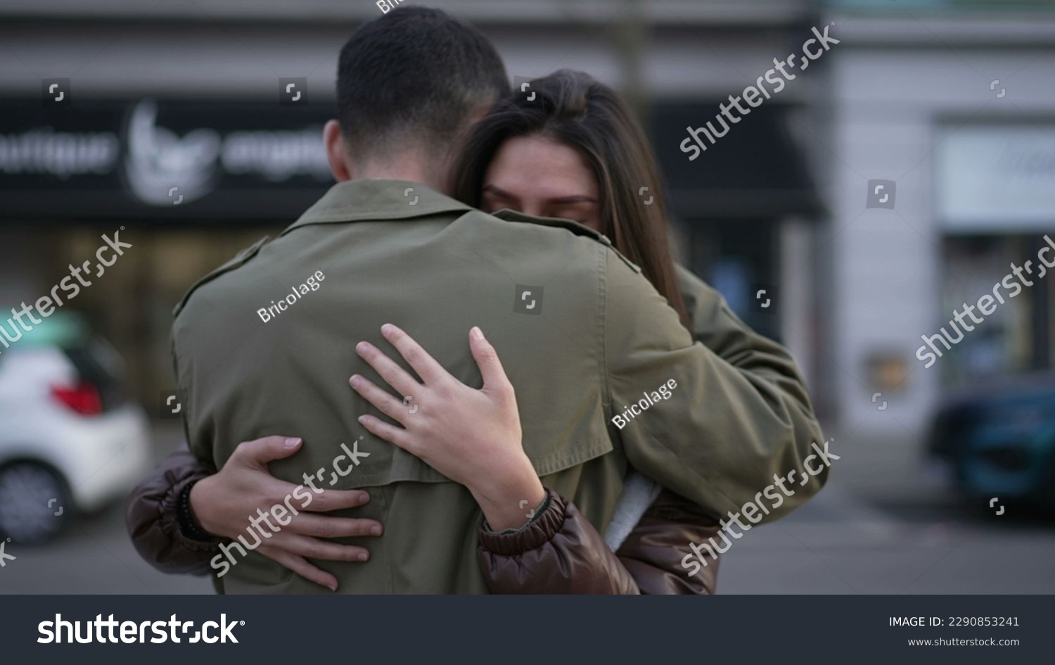 Young couple romantic embrace outside in urban street. Man consoling girlfriend suffering from problems. Empathic relationship concept #2290853241