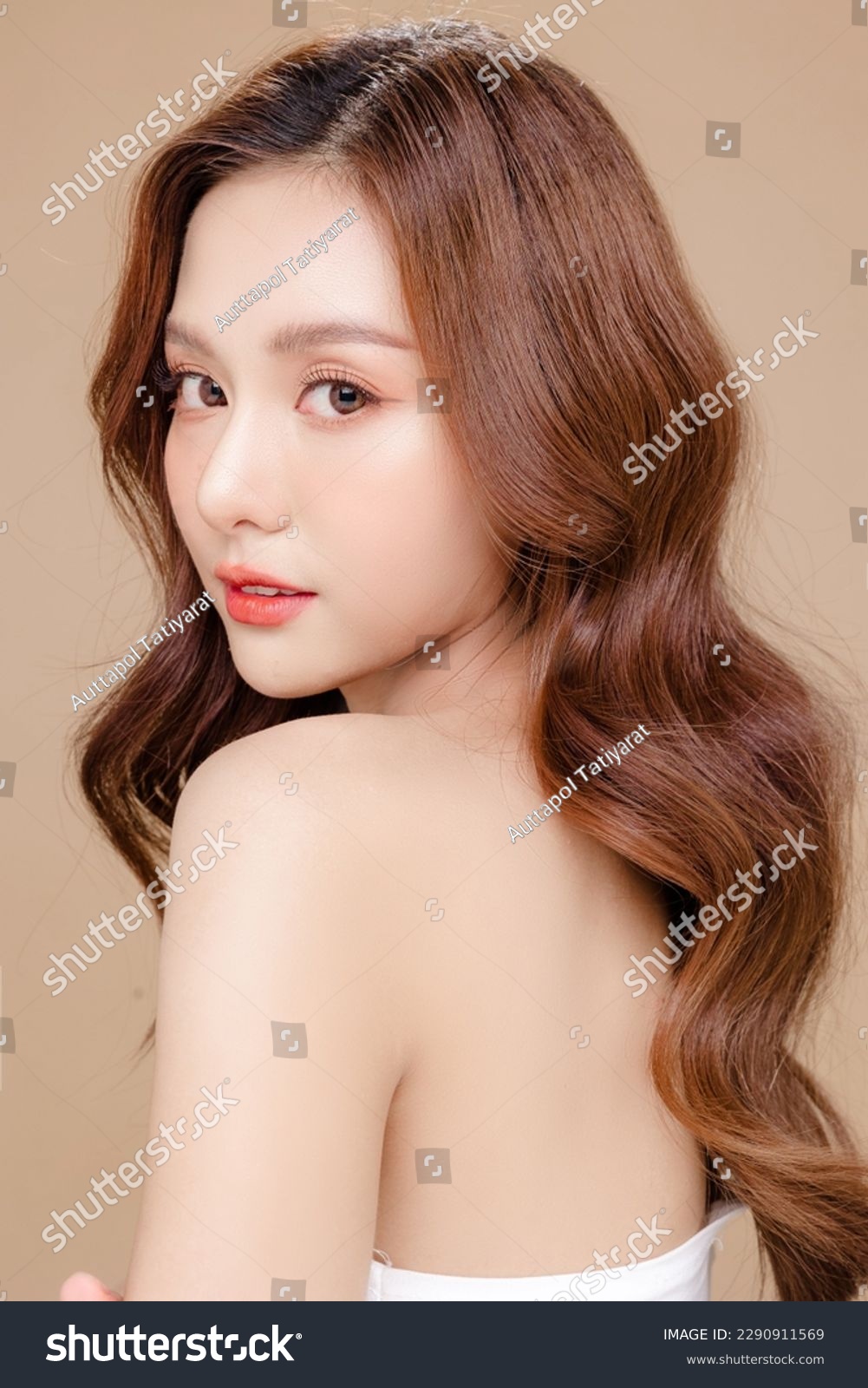 Young Asian beauty woman curly long hair with korean makeup style on face and perfect skin on isolated beige background. Facial treatment, Cosmetology, plastic surgery. #2290911569