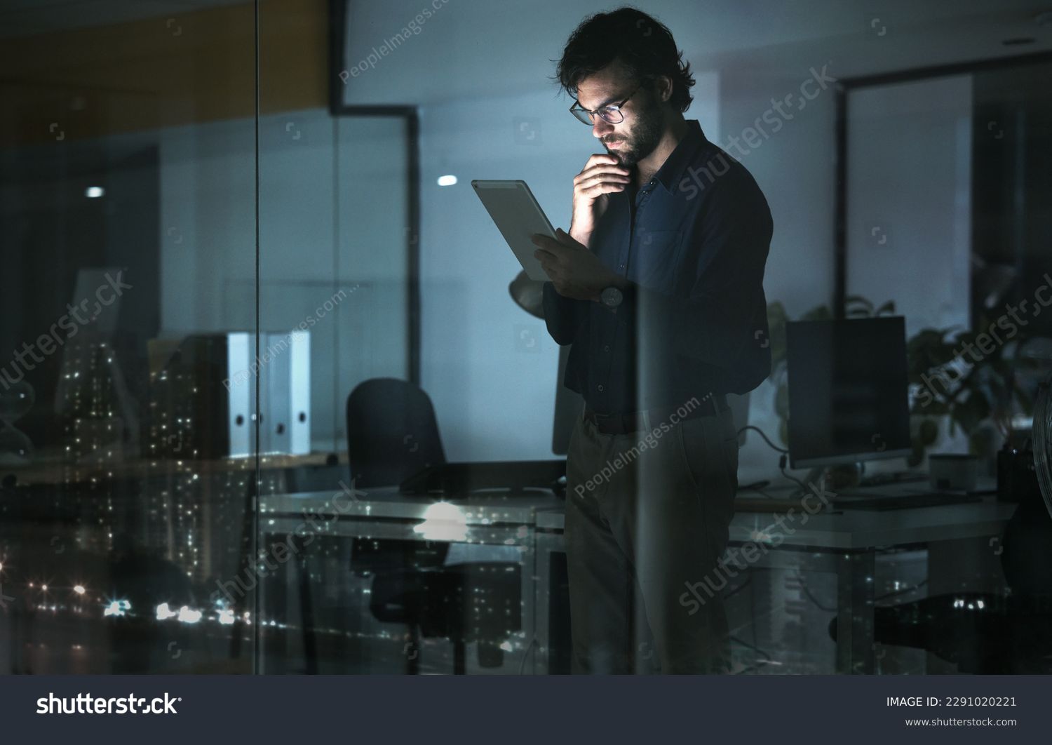 Business man, tablet and thinking in office, problem solving or looking for solution by window with city lights at night. Technology, idea and professional person with touchscreen to focus on reading #2291020221
