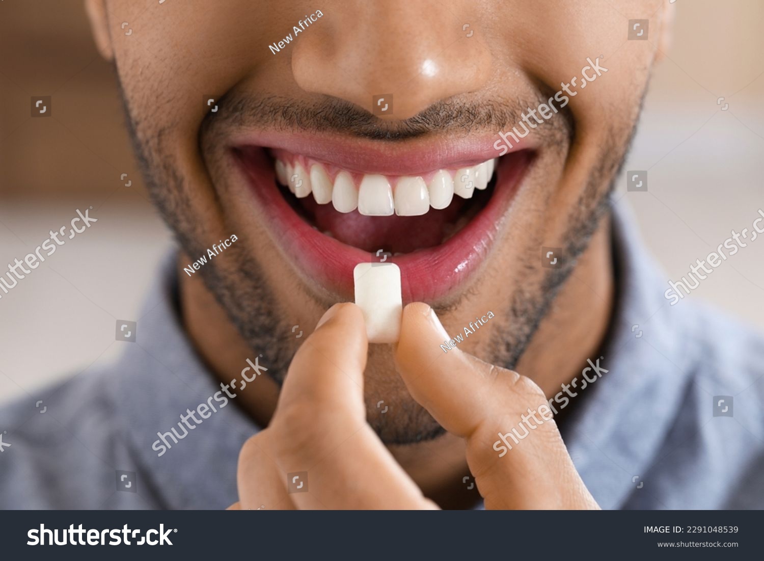 Man with chewing gum on blurred background, closeup #2291048539