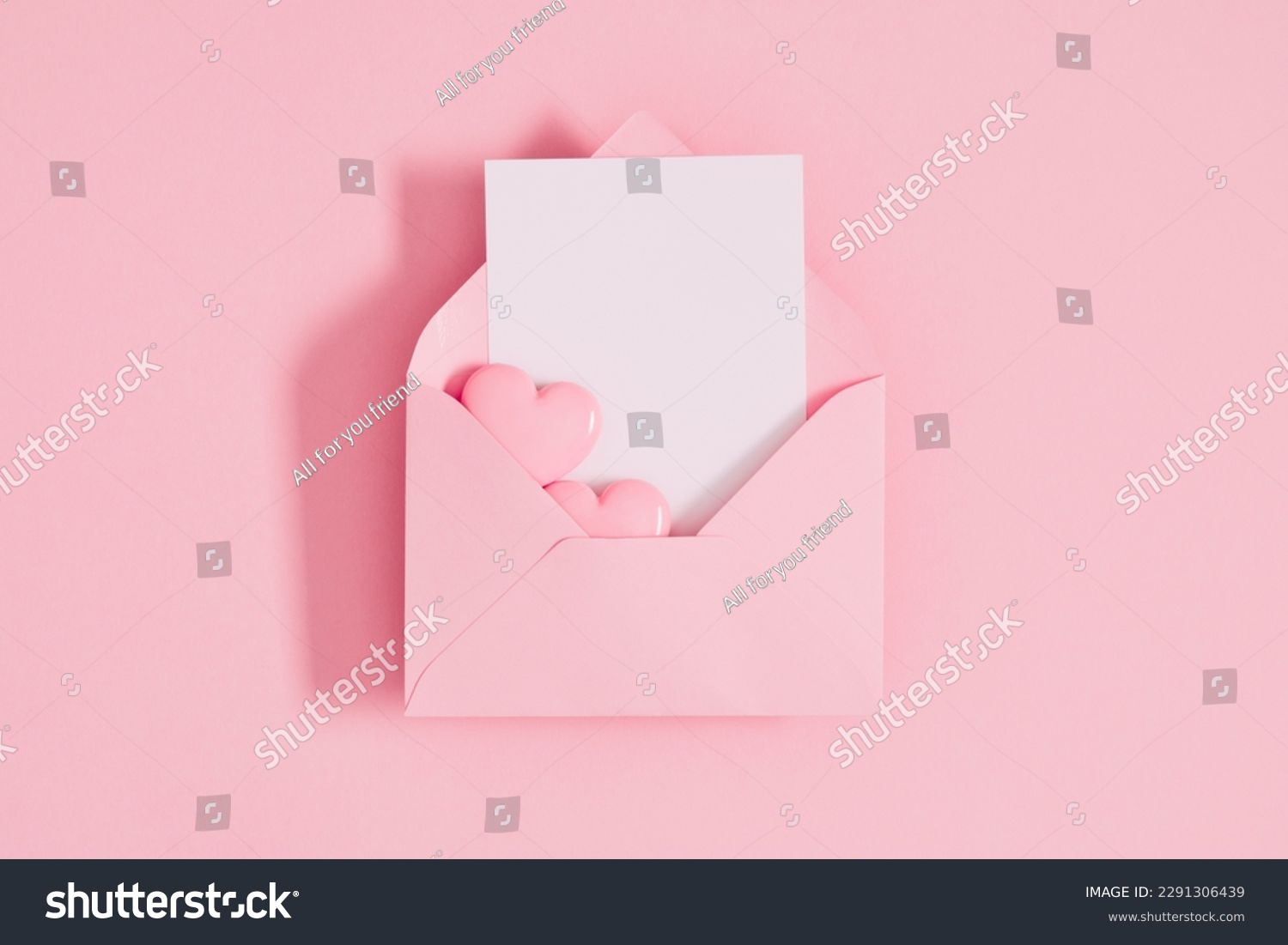 Open pink envelope with paper card and heart on pastel pink table background. Birthday, Wedding, Mother's Day, Valentine's day, Women's Day. Flat lay, top view, copy space #2291306439