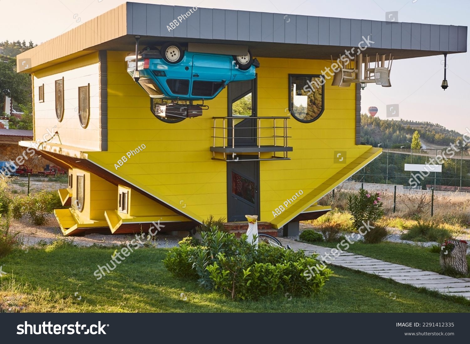 Weird upside down house. Bizarre wooden home. Funny architecture #2291412335