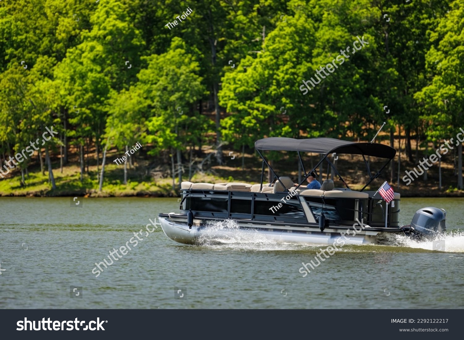 Boater on pontoon boat enjoying summer day on Lake. Pontoon party boat cruising on freshwater lake. #2292122217