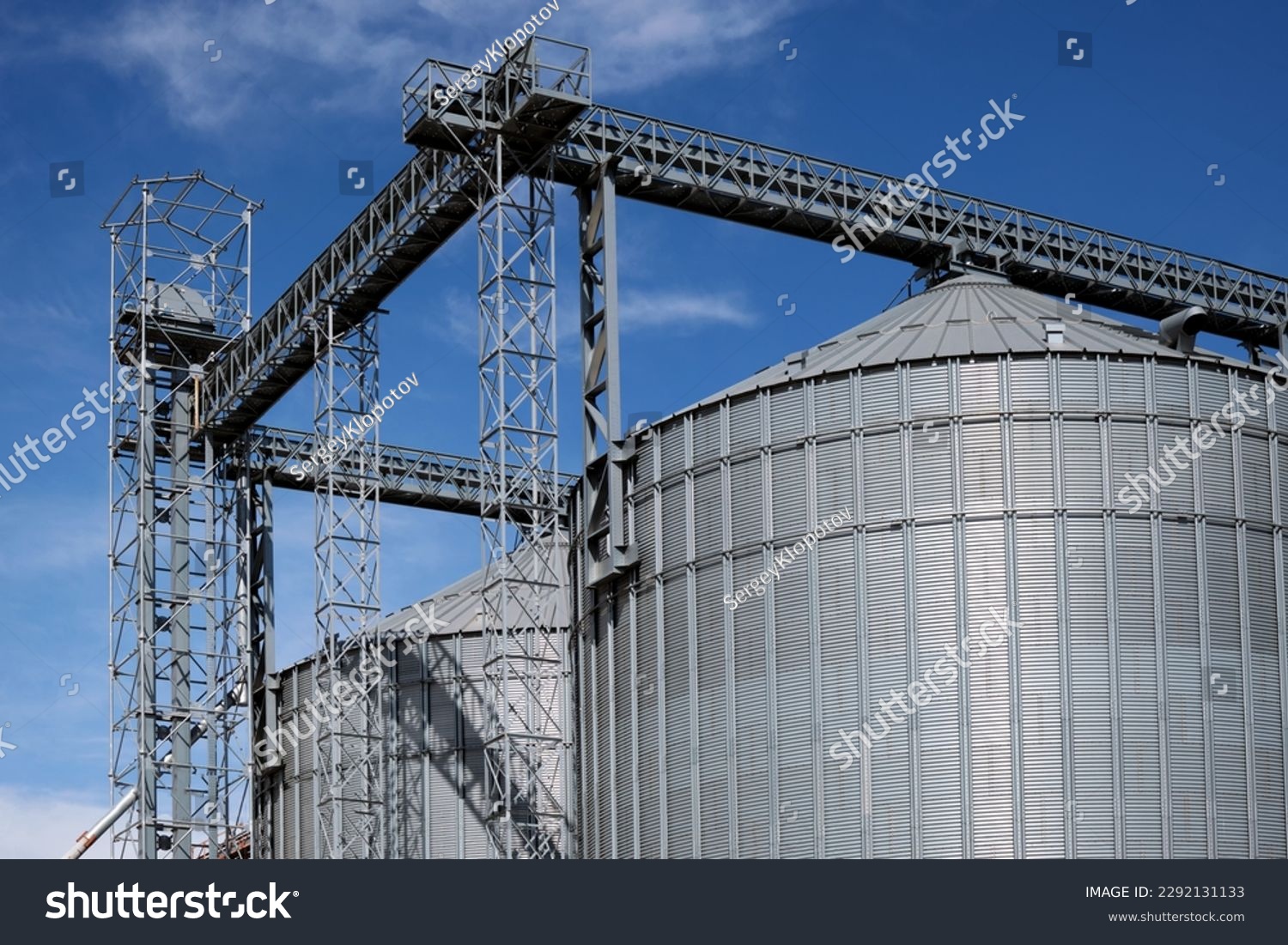 Industrial facilities of feed and flour mills. Close-up of steel grain storage silos with conical bottom, can be used for various purposes. #2292131133