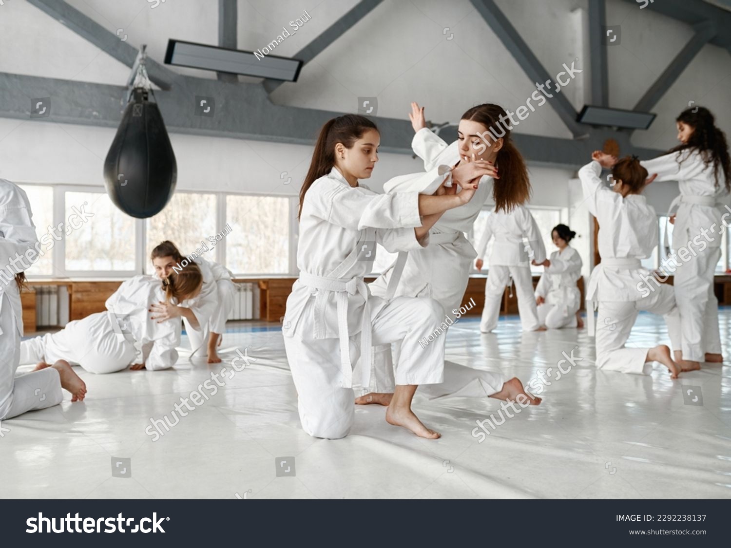 Teenage girls fighting at aikido training in martial arts school #2292238137