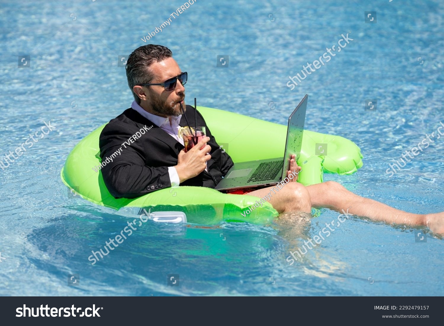 Summer business dreams. Business man in suit floating with cocktail and laptop in swimming pool. Summer business vacation. Funny crazy businessman rest in formal wear in pool. Hot summer business. #2292479157