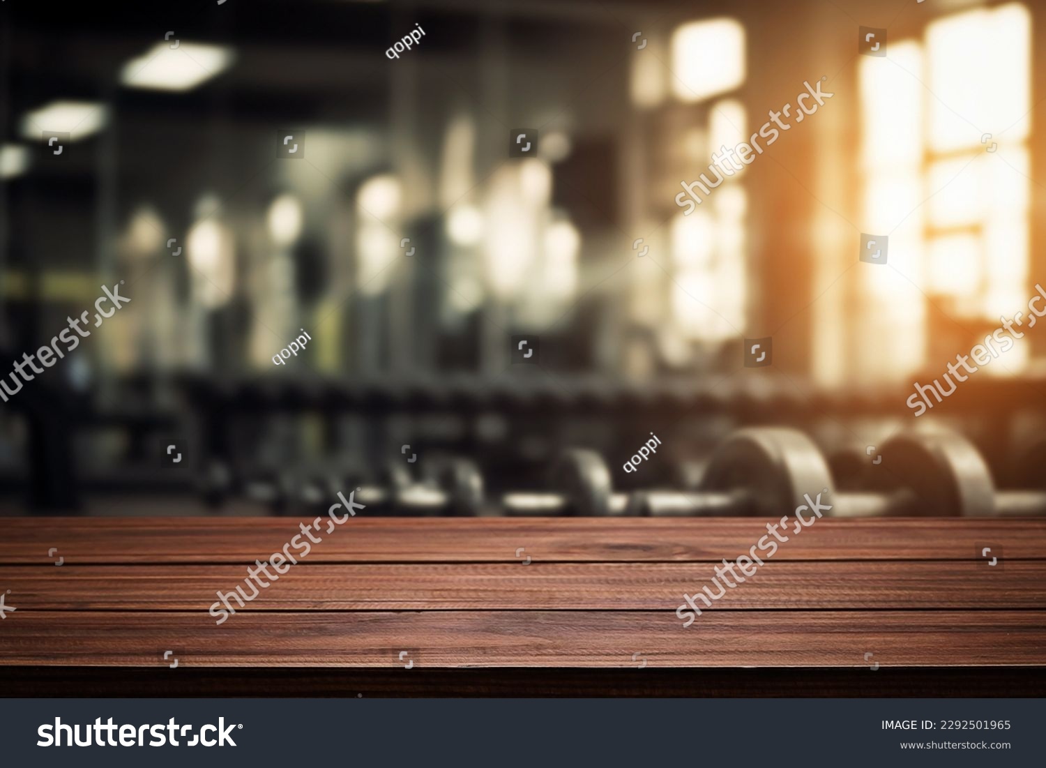 Blurred background of fitness gym and wooden table free space for product display. #2292501965