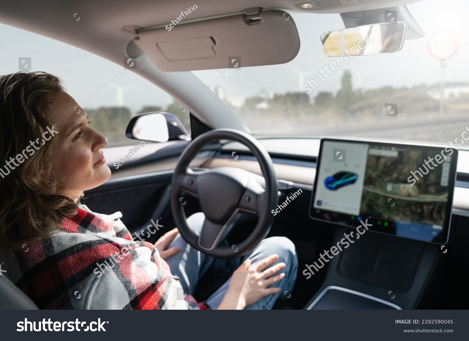 Woman resting while her car is driven by an autopilot. Self driving vehicle concept #2292590045