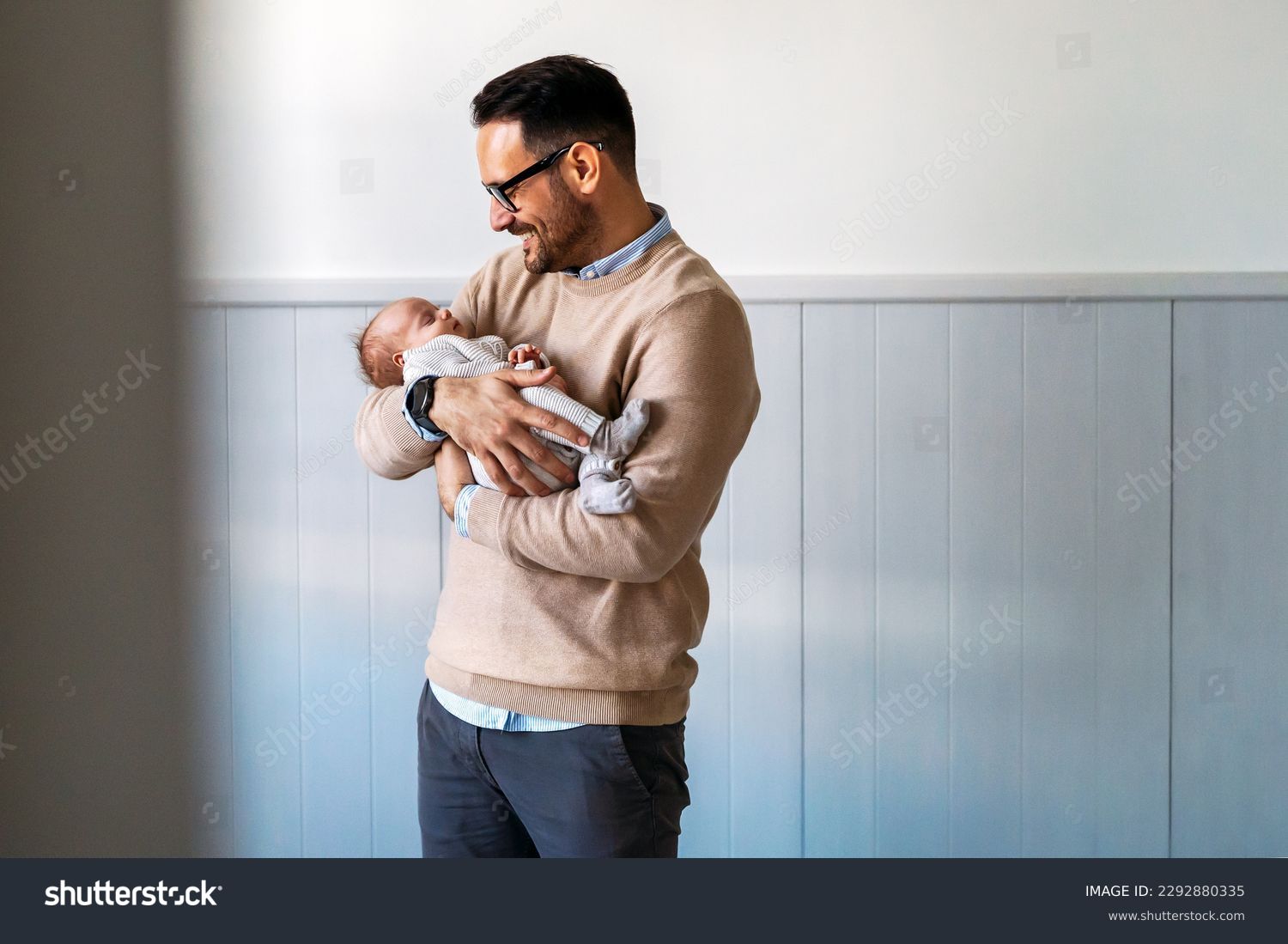 Portrait of young father holding his newborn baby. Fatherhood love single dad fathers day concept. #2292880335