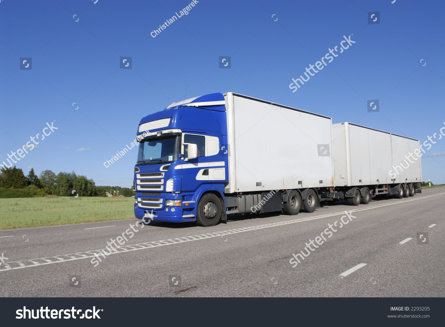 blue and white lorry, truck driving in country-road #2293205