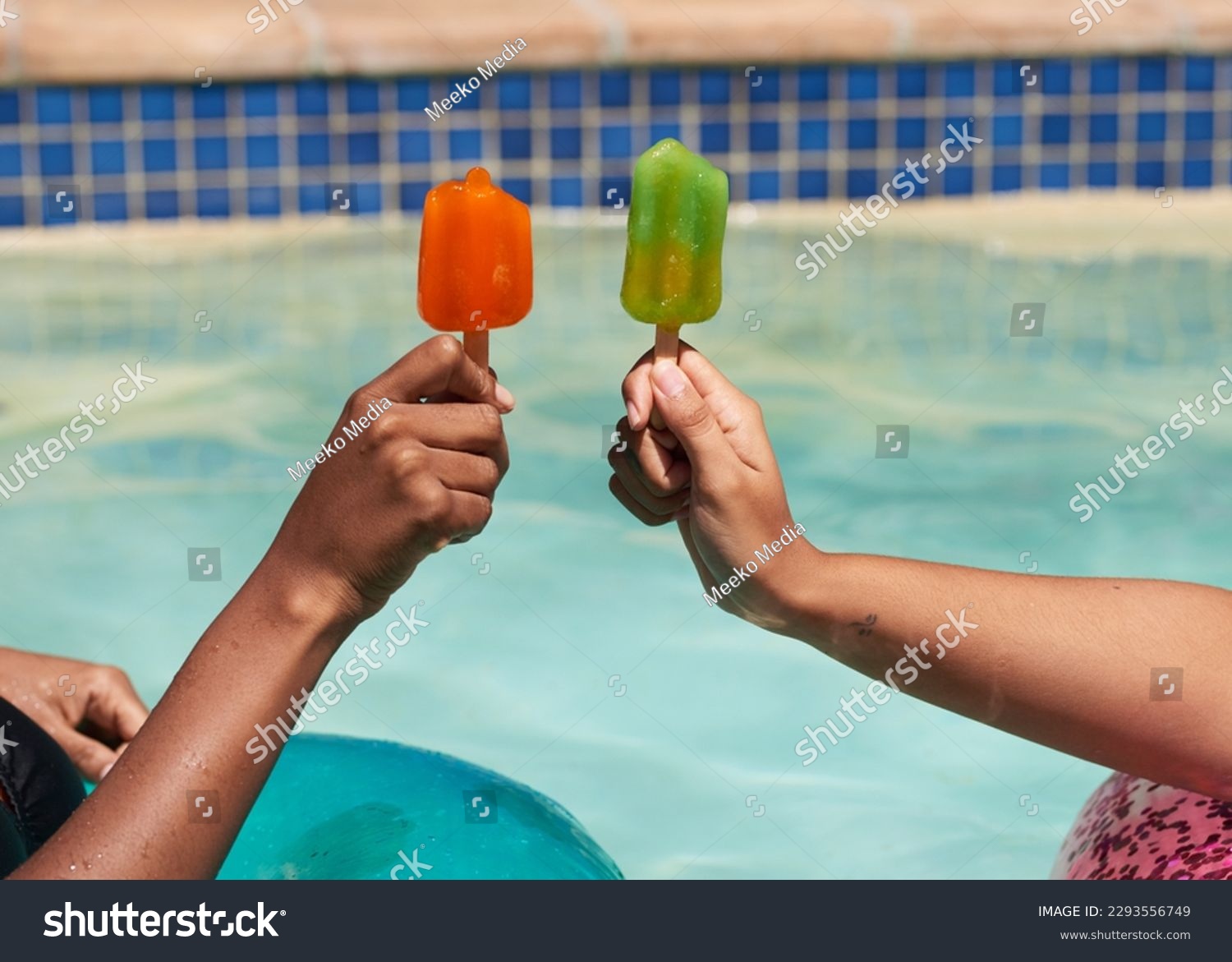 Close up of friends holding ice lolly popsicles in the swimming pool, beat heat #2293556749