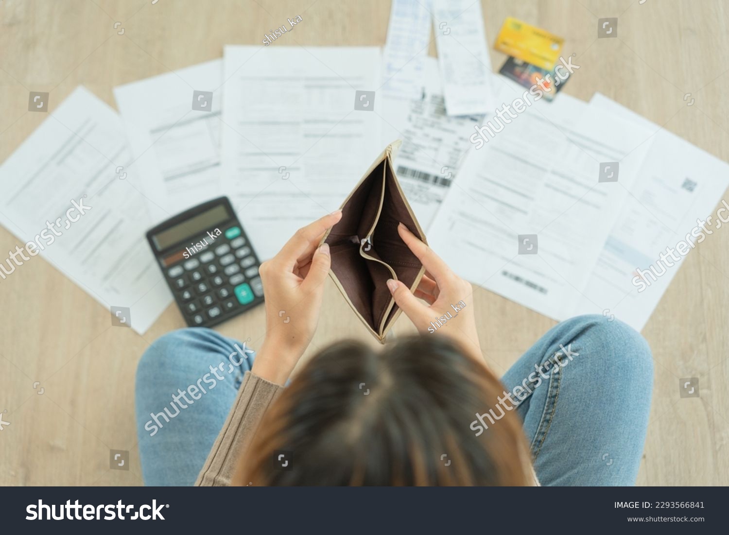 Stressed and headache woman with large bills or invoices no money to pay to expenses and credit card debt. shortage, Financial problem, bankruptcy, mortgage, loan, bankrupt, poor, empty wallet  #2293566841