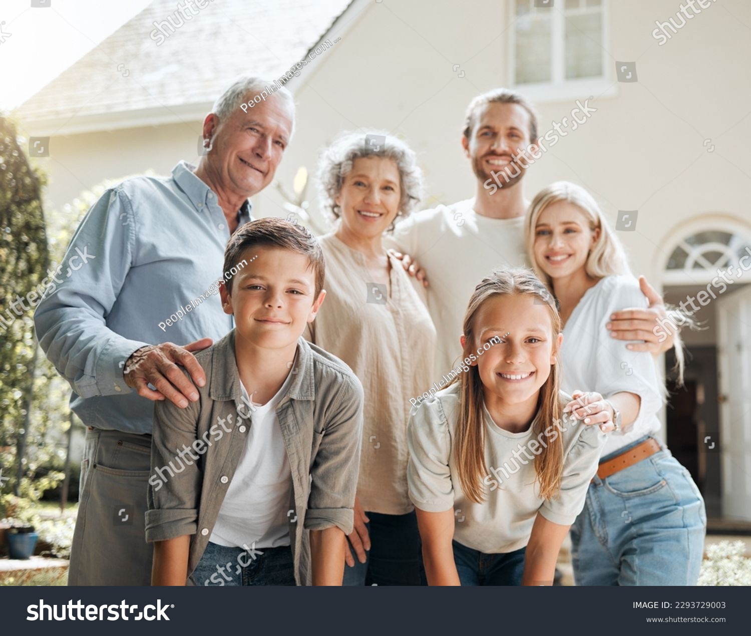 Keep your family close. Shot of a multi-generational family standing together outside. #2293729003