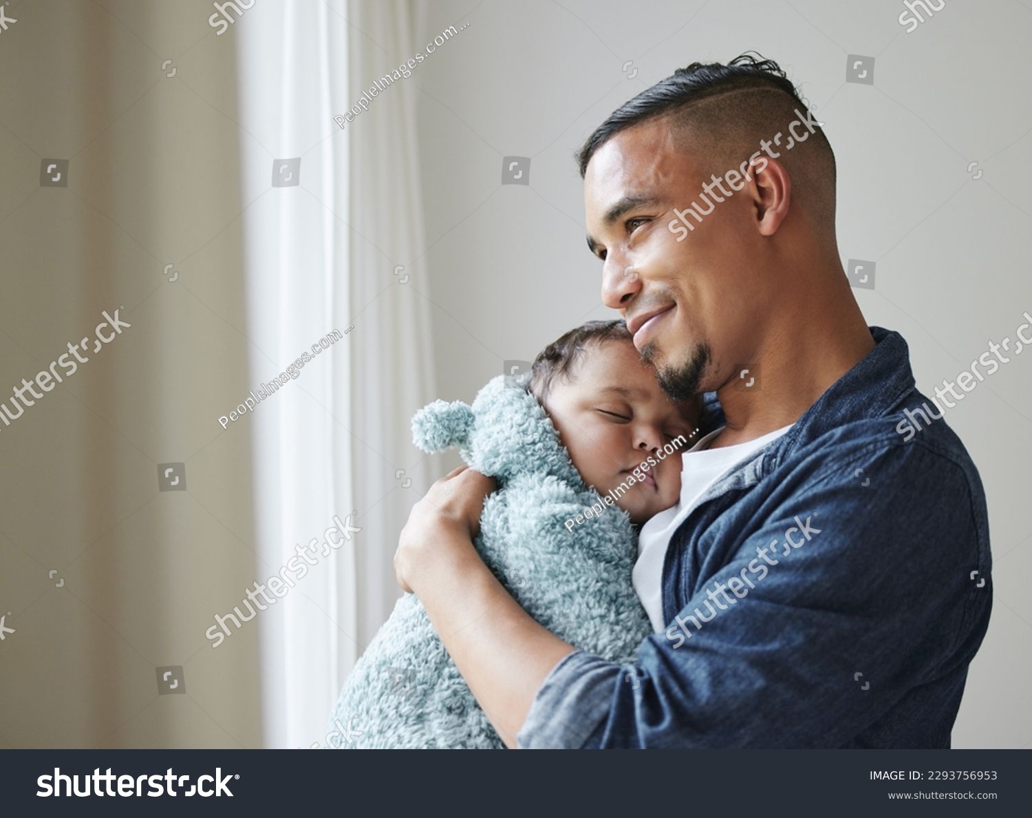 This is the best feeling. Shot of a young father embracing his baby at home. #2293756953
