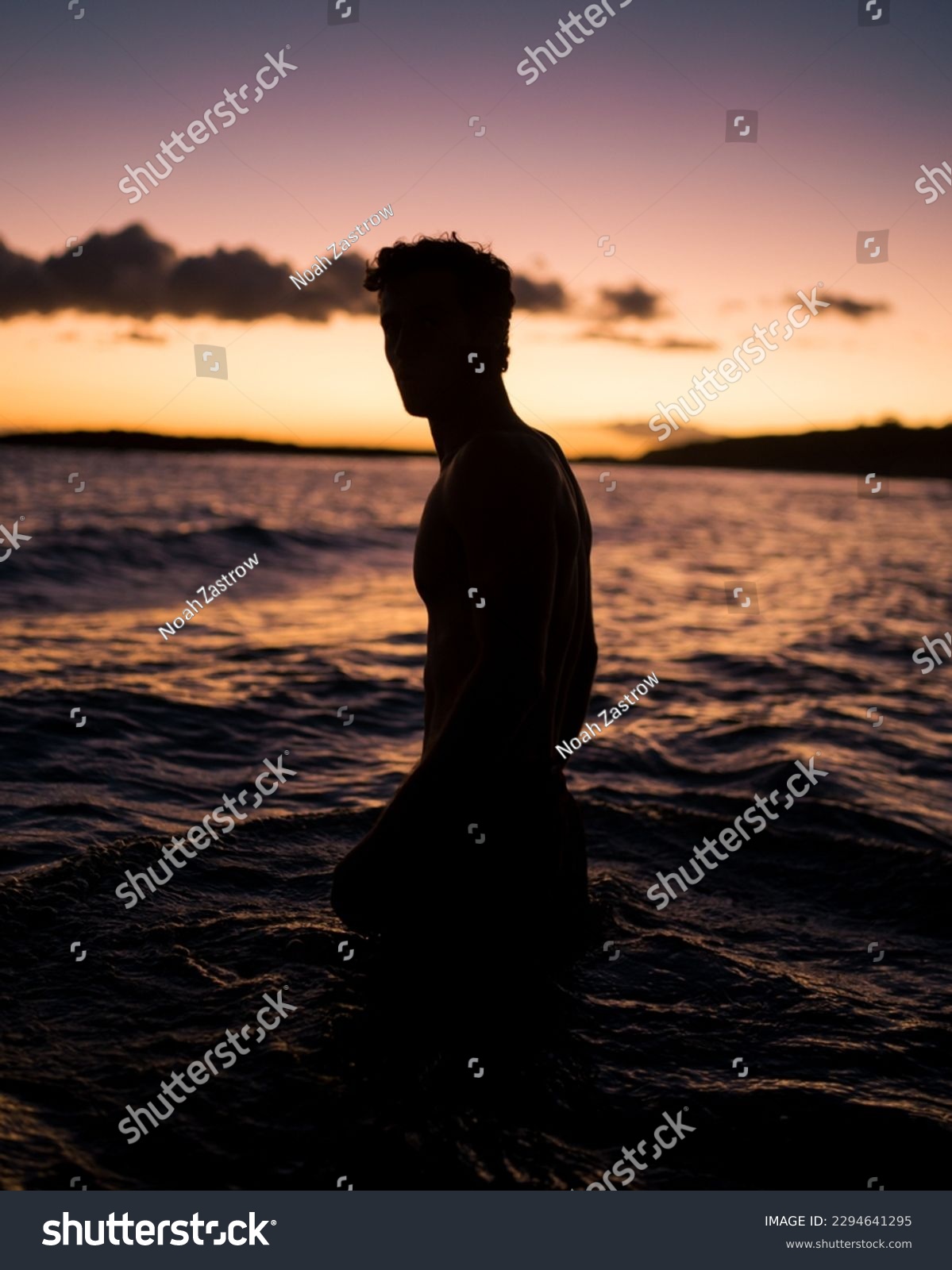 Man wading in the water at Sunset beach in Hawaii #2294641295