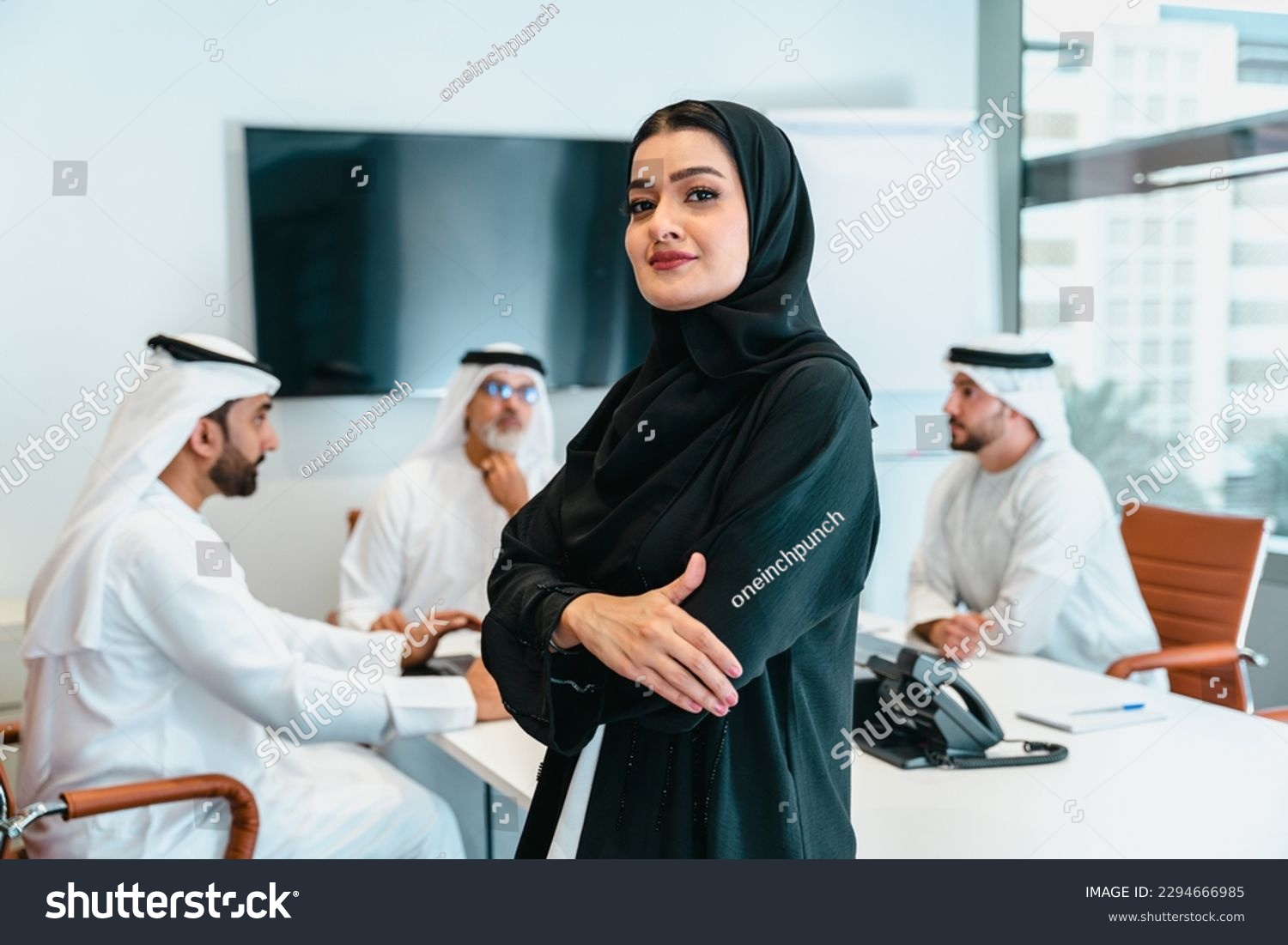 Group of middle-eastern corporate business people wearing traditional emirati clothes meeting in the office in Dubai - Business team working and brainstorming in the UAE #2294666985