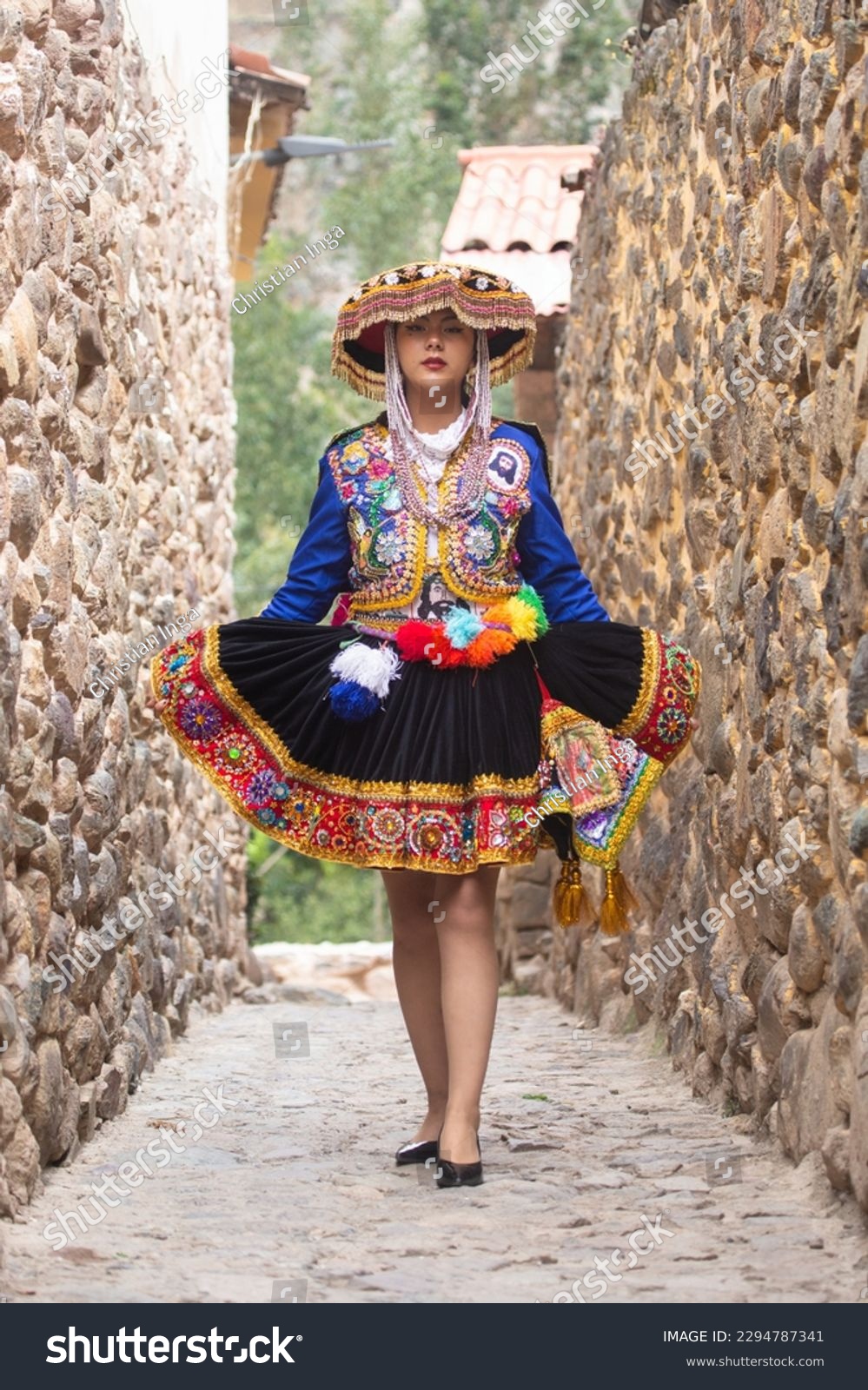Beautiful girl with traditional dress from Peruvian Andes culture. Young girl in Ollantaytambo city in Incas Sacred Valley in Cusco Peru. #2294787341
